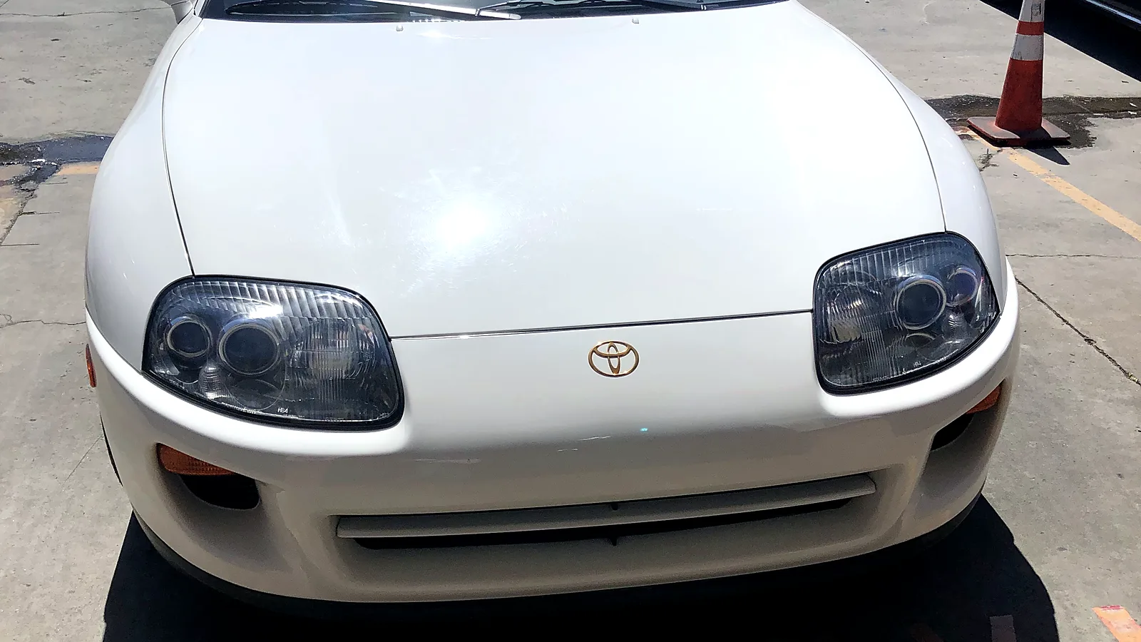 Change-of-ownership smog check in Escondido, CA: white Toyota Supra in the lot