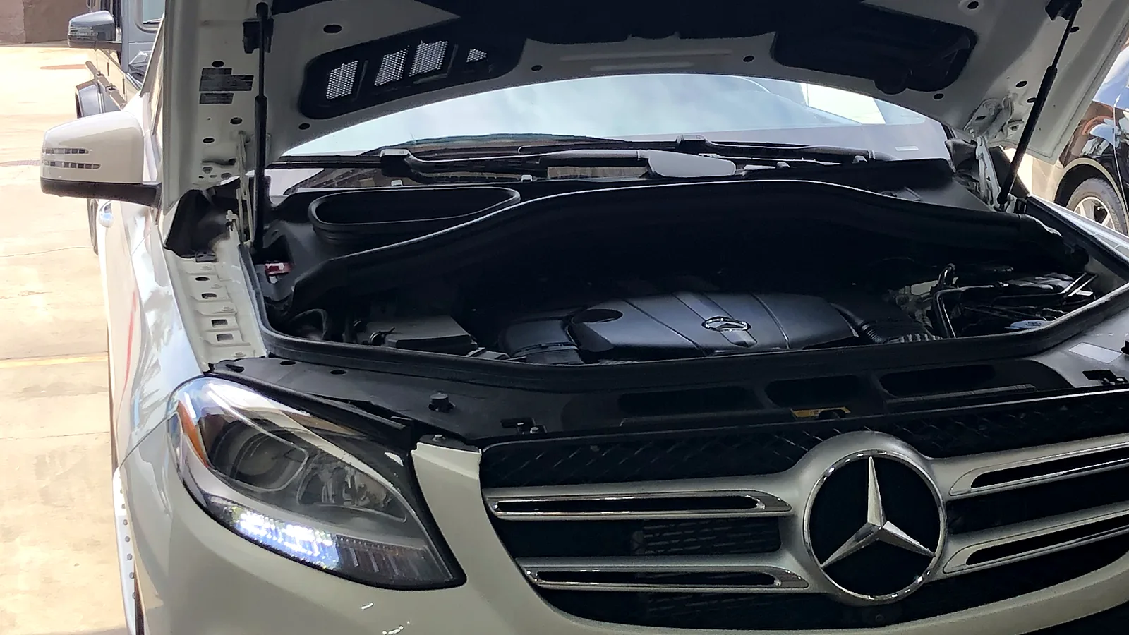 Hybrid smog check in Escondido, CA: Mercedes-Benz SUV with the hood open