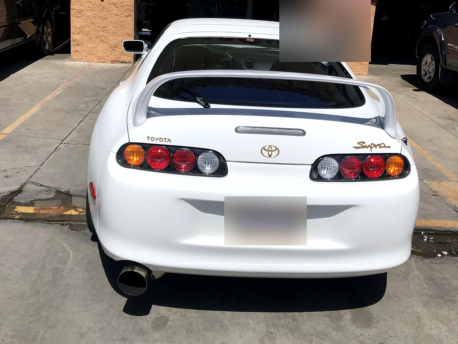 STAR smog check in Escondido, CA: Toyota Supra in front of our bay under the Smog Station banner